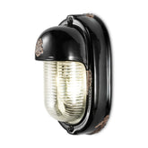 Antikolt felületű mázas kerámiából és bordázott üvegből készült kézműves falilámpa.